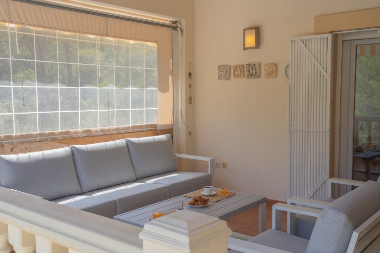 Covered terrace with dining table at Villa Casa Joni in Orba