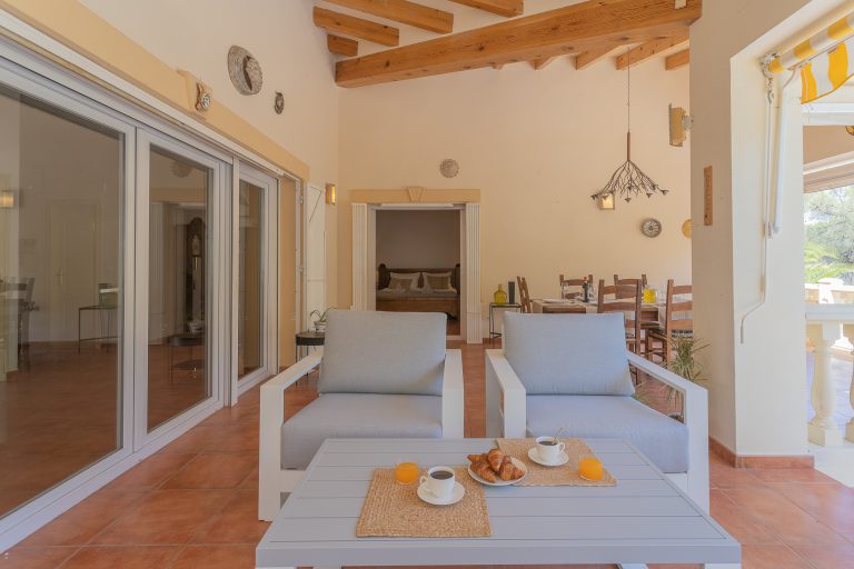 Covered terrace with dining table at Villa Casa Joni in Orba